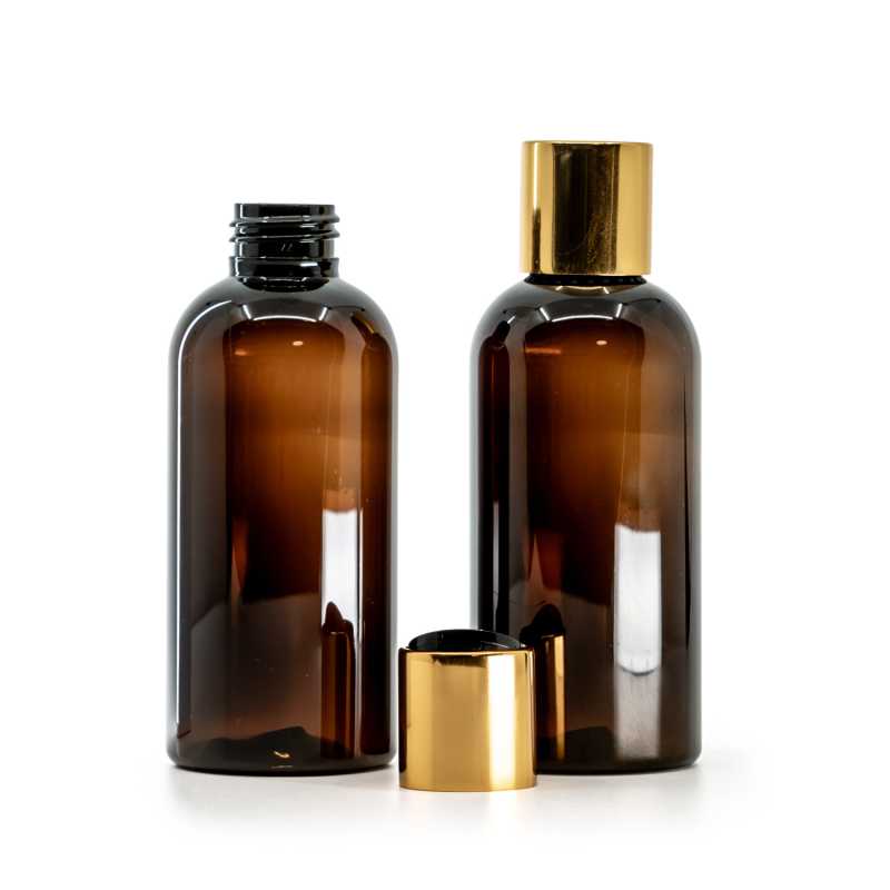 Botella de plástico ámbar, tapón disc-top dorado con centro negro, 150 ml