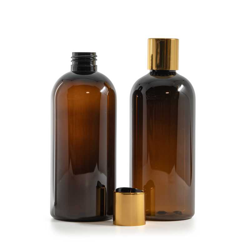 Botella de plástico ámbar, tapón disc-top dorado con inserto negro, 300 ml