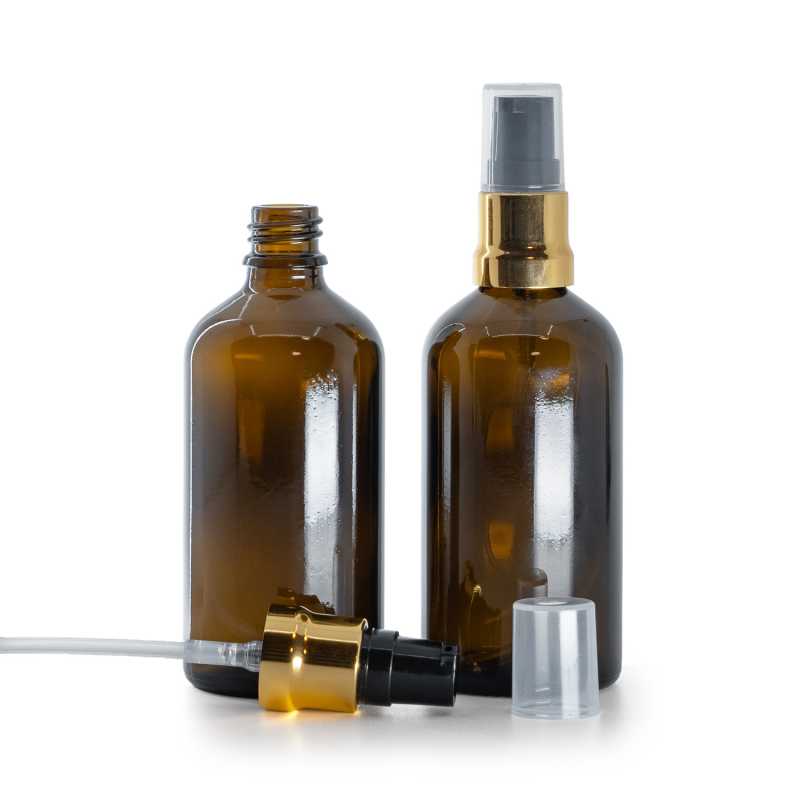 Botella de vidrio, ámbar, dispensador negro y dorado brillante con tapa transparente, 100 ml